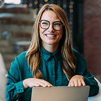 Smiling woman in a teal blouse